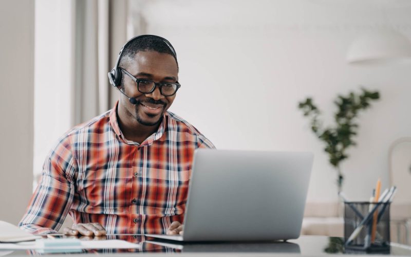 african-american-male-student-wearing-headset-learn-language-online-at-laptop-distance-education.jpg